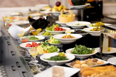a buffet line with many plates of food on it at Bulton Hotel Airport in Arnavutköy