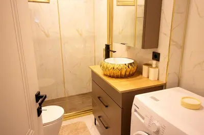 a bathroom with a sink and a toilet and a shower at Brand-New Stylish 2BR by the Coast in Yedikule in Istanbul