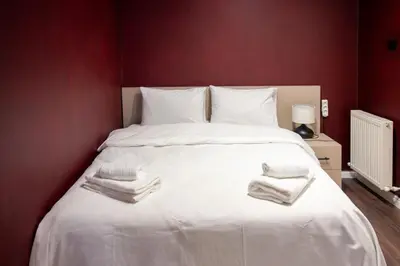 a bedroom with a white bed with towels on it at Brand-New Stylish 2BR by the Coast in Yedikule in Istanbul
