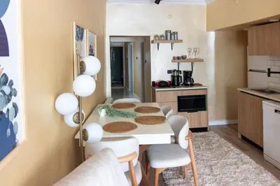 a kitchen with a table and chairs in a room at Brand-New Stylish 2BR by the Coast in Yedikule in Istanbul