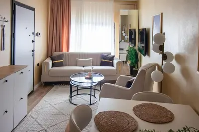 a living room with a couch and a table at Brand-New Stylish 2BR by the Coast in Yedikule in Istanbul