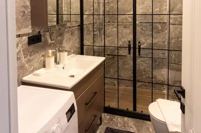 a bathroom with a sink and a toilet at Modern & Stylish 2BR Haven by the Sea in Yedikule in Istanbul
