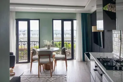 a kitchen with a table and chairs in a room at Modern & Stylish 2BR Haven by the Sea in Yedikule in Istanbul
