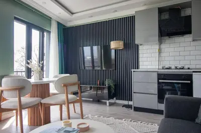 a kitchen with a table and chairs in a room at Modern & Stylish 2BR Haven by the Sea in Yedikule in Istanbul