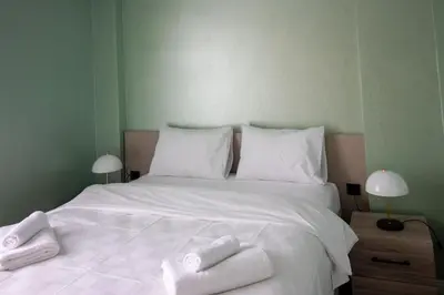 a white bed with two towels on top of it at Modern & Stylish 2BR Haven by the Sea in Yedikule in Istanbul
