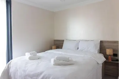 a bedroom with a white bed with towels on it at Classy 2BR Hideaway with Dazzling Panorama in Istanbul