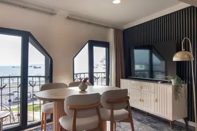 a dining room with a table and chairs and windows at Classy 2BR Hideaway with Dazzling Panorama in Istanbul