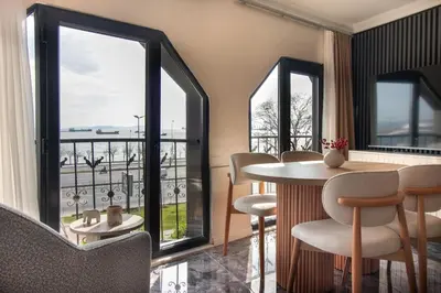 a room with a table and chairs and windows at Classy 2BR Hideaway with Dazzling Panorama in Istanbul