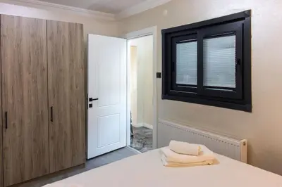 a bedroom with a white bed and a window at Classy 2BR Hideaway with Dazzling Panorama in Istanbul
