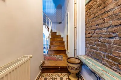 a stairway with a brick wall and a stair case at Historic Balat 2BD2Bath Central House! #388 in Istanbul