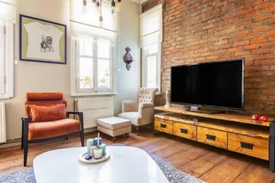 a living room with a brick wall and a flat screen tv at Historic Balat 2BD2Bath Central House! #388 in Istanbul