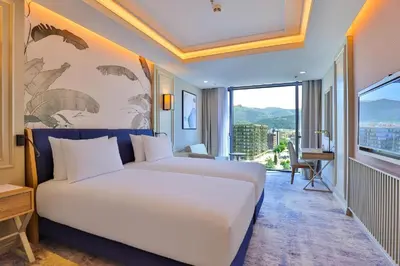 a bedroom with a white bed and a large window at Sia Hotel Thermal & Spa in Nilüfer
