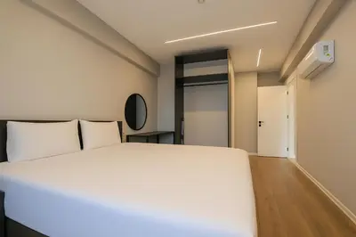 a bedroom with a large white bed and a hallway at Sia Hotel Thermal & Spa in Nilüfer