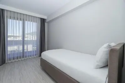 a white room with a bed and a large window at Sia Hotel Thermal & Spa in Nilüfer