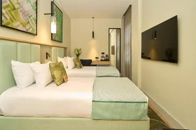 a hotel room with two beds with pillows at The Wings Hotels Pera in Istanbul