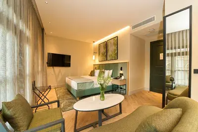a hotel room with a bed and a table and chairs at The Wings Hotels Pera in Istanbul