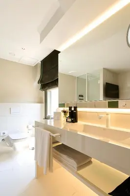 a white bathroom with a sink and a toilet at The Wings Hotels Pera in Istanbul