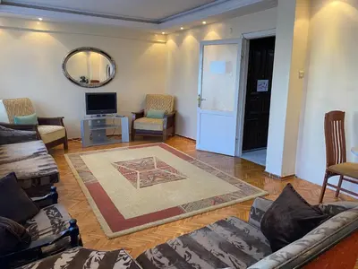a living room with a couch and chairs and a mirror at Spacious apartment very close to the tram in Istanbul