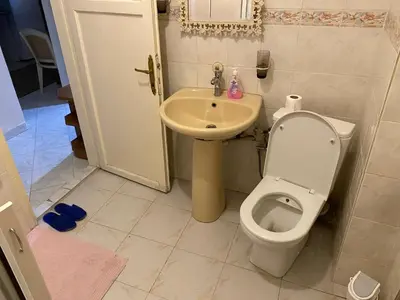 a bathroom with a toilet and a sink at Spacious apartment very close to the tram in Istanbul