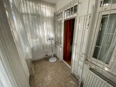 a bathroom with a toilet in a room with windows at Spacious apartment very close to the tram in Istanbul