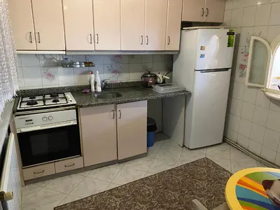 a kitchen with a stove and a refrigerator at Spacious apartment very close to the tram in Istanbul