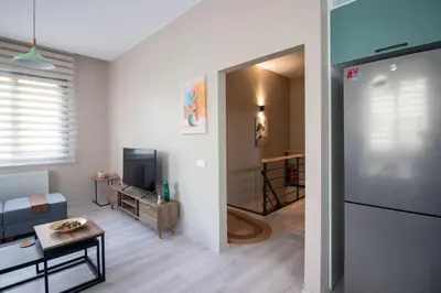 a living room with a couch and a television at Beautifully Designed 3BR Duplex in Prime Göktürk in Kemerburgaz