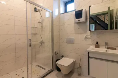 a bathroom with a shower and a toilet and a sink at Beautifully Designed 3BR Duplex in Prime Göktürk in Kemerburgaz