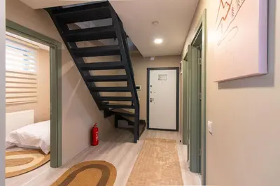 a staircase in a room with a bedroom at Beautifully Designed 3BR Duplex in Prime Göktürk in Kemerburgaz