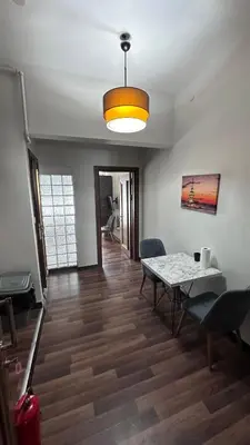 a dining room with a table and a light at Echoloft İstanbul- Nişantaşı in Istanbul