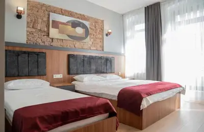 a hotel room with two beds and a window at House with balcony in Galata 2 in Istanbul