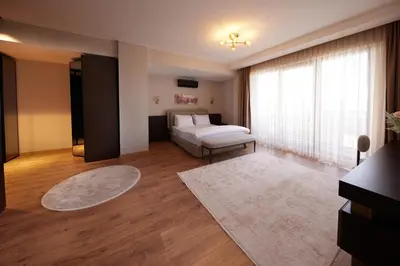 a living room with a bed and a window at Andalus Villas Lake View NO ALCOHOL ALLOWED with Heated Pool in Sakarya
