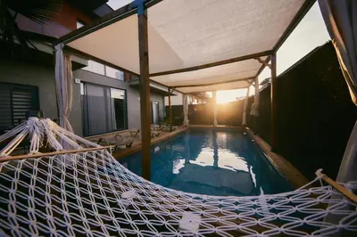 a hammock in a house with a swimming pool at Andalus Villas Lake View NO ALCOHOL ALLOWED with Heated Pool in Sakarya