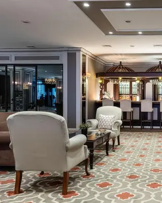 a lobby with chairs and a table and a bar at Hotel Yigitalp Istanbul in Istanbul