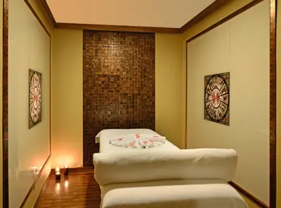 a room with two white stools and a brick wall at Hotel Yigitalp Istanbul in Istanbul
