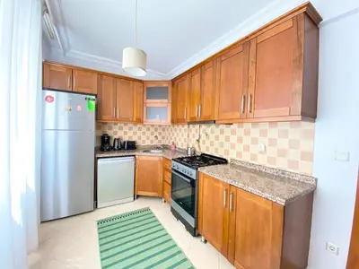 a kitchen with wooden cabinets and a stainless steel refrigerator at Near Nişantasi & Stylish No1 in Istanbul