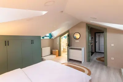 a bedroom with a large bed and a bathroom at Göktürk's Finest 2BR Stylish, Spacious & Prime in Kemerburgaz