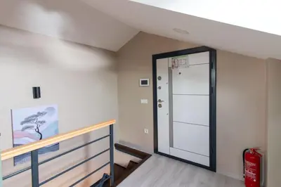 an empty hallway with a door in a house at Göktürk's Finest 2BR Stylish, Spacious & Prime in Kemerburgaz