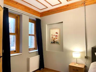 a bedroom with a coffered ceiling and windows at Soil balat in Istanbul
