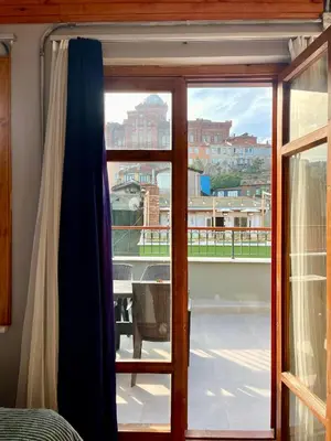 a glass door with a view of a balcony at Soil balat in Istanbul