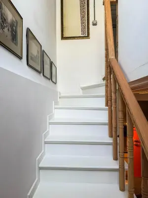 a staircase in a home with white paint and wood railings at Sel Maison in Istanbul