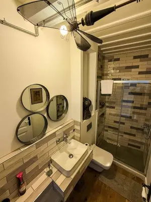 a bathroom with a sink and a toilet and mirrors at Sel Maison in Istanbul