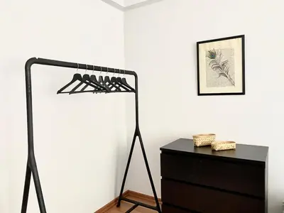 a black rack of wine bottles next to a dresser at Central & Spacious Flat - No5 in Istanbul