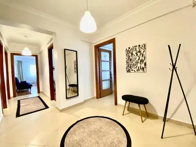 a living room with a black chair and a table at Central & Spacious Flat - No5 in Istanbul