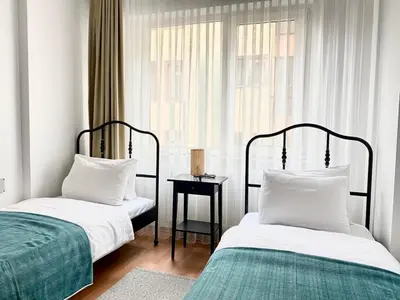 a bedroom with two beds and a window at Central & Spacious Flat - No5 in Istanbul
