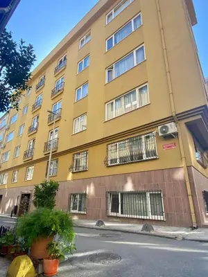 a yellow building with barred windows on a street at Gorgeous 3 Bedroom Flat - No8 in Istanbul