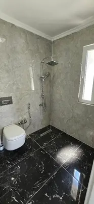 a bathroom with a toilet and a shower at Luxury villa with sea and forest view in Döngel