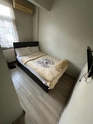 a small bedroom with a bed in the corner at Şebnem Hotel in Istanbul
