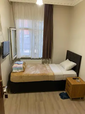 a bedroom with a large bed with a window at Şebnem Hotel in Istanbul