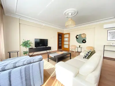 a living room with white furniture and a flat screen tv at City Center Spacious Flat No9 in Istanbul