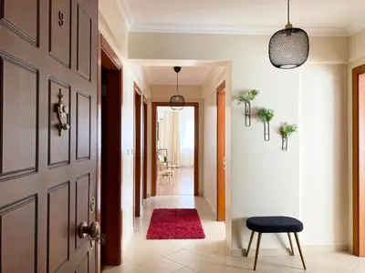 a hallway with a door and a red rug at City Center Spacious Flat No9 in Istanbul